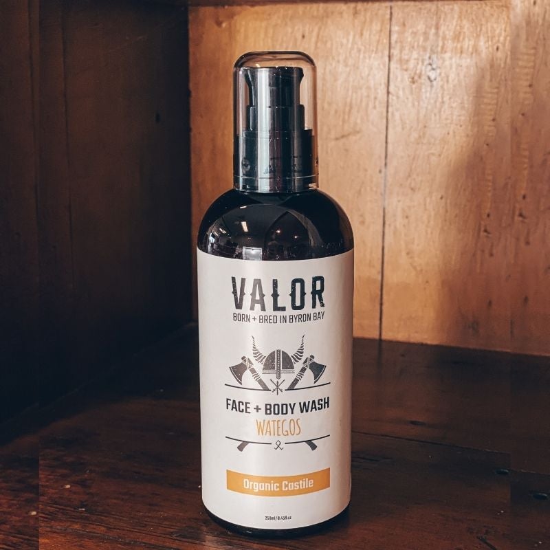 Bottle of Valor face and body wash on a wooden surface